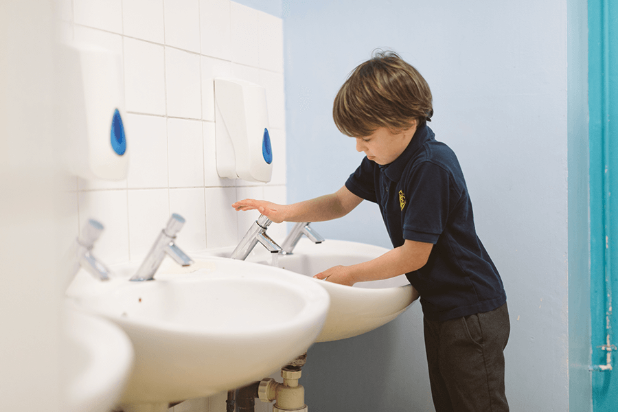 Young boy washing hands