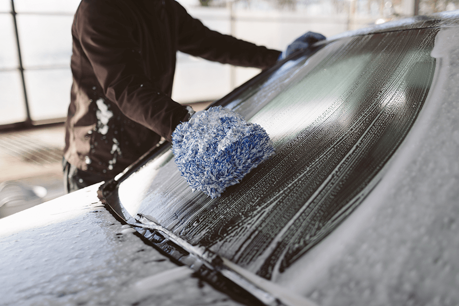 Man washing a car windscreen